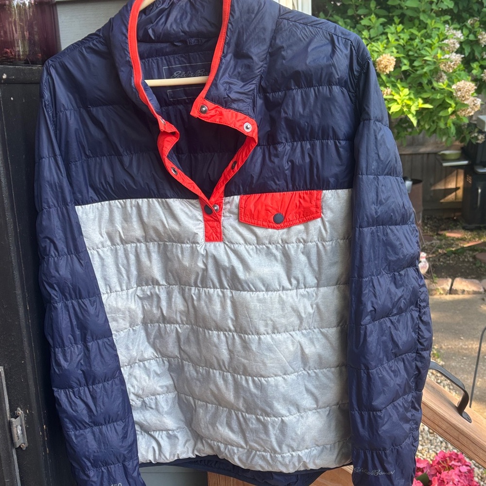 Women’s Eddie Bauer and Silver Puffer Pullover Jacket with orange trim.